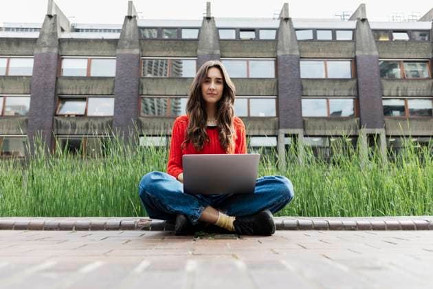 Woman using laptop outside university building model released, Symbolfoto, ASGF06613