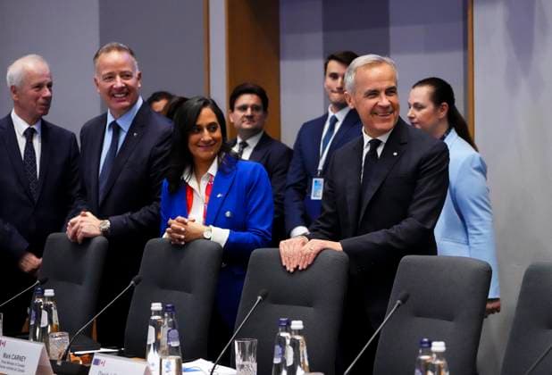 June 23, 2025, Brussels, Belgium: Canadian Minister of Foreign Affairs Anita Anand, centre, is flanked by Canadian Secretary of State (Defence Procurement) Stephen Fuhr, left, and Prime Minister Mark Carney, right, as they wait for the start of a plenary session at the Canada EU Summit in Brussels, Belgium on Monday, June 23, 2025. Brussels Belgium - ZUMAc35_ 20250623_zaf_c35_054 Copyright: xSeanxKilpatrickx