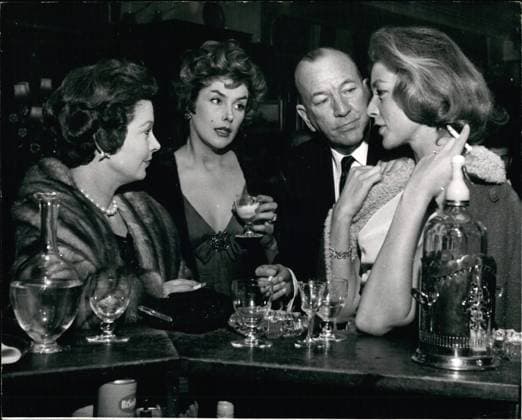 Bands Komponisten Instrumente Musiker Oper Orchester Schallplatten Sänger Songwriter Symphonien 29. Januar 1959 - 29.1.59 Der glückliche Knappe von London, Noel Coward, begleitet drei faszinierende Frauen. Mr. Noel Coward war gestern Abend sicherlich der glücklichste Mann Londons, als er, strahlend wie ein gütiger Sultan, drei der faszinierendsten Frauen der Welt, Kay Kendall, Vivian Leigh und Lauren Bacall, ins St. Martins Theatre begleitete. Sie gingen, um The Grass is Greener mit ihrer gemeinsamen Freundin Celia Johnson in der Hauptrolle zu sehen. Die Party war von Vivian Leigh organisiert worden. Foto zeigt: In der Pause lädt Noel das Trio auf einen Drink ein und hier plaudert er an der Bar mit (von links na  Copyright: xUnitedxArchivesx xkpaxKeystonex 19590129_baf_k09_002