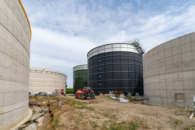 New construction of a large biogas plant Steiger in the middle of huge concrete elevated tanks, symbolic photo New construction of a biogas plant and a biogas treatme