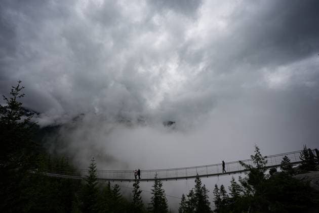 June 26, 2025, Squamish, Bc, CANADA: People are silhouetted while walking on a suspension bridge at the Sea-to-Sky Gondola in Squamish, B.C., on Thursday, June 26, 2025. The Squamish Nation and the provincial government have signed an agreement to guide forest stewardship in the nation s territory to protect cultural sites and environmentally sensitive areas from logging, new roads and tenures. The agreement establishes 33 cultural sites and six special cultural management areas. Squamish CANADA  - ZUMAc35_ 20250626_zaf_c35_029 Copyright: xDarrylxDyckx