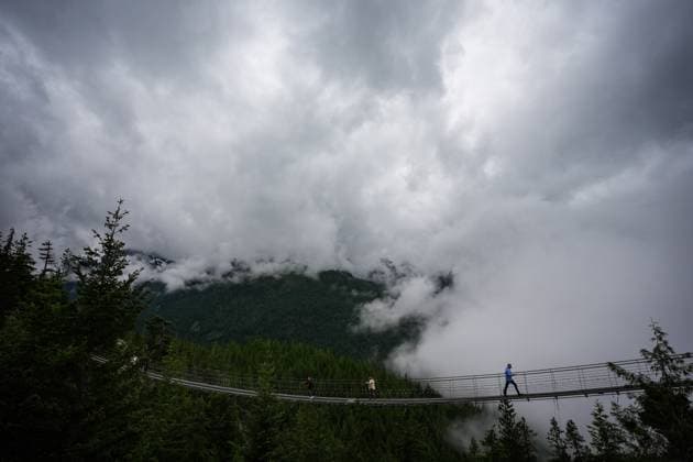 June 26, 2025, Squamish, Bc, CANADA: People walk across a suspension bridge at the Sea-to-Sky Gondola in Squamish, B.C., on Thursday, June 26, 2025. The Squamish Nation and the provincial government have signed an agreement to guide forest stewardship in the nation s territory to protect cultural sites and environmentally sensitive areas from logging, new roads and tenures. The agreement establishes 33 cultural sites and six special cultural management areas. Squamish CANADA  - ZUMAc35_ 20250626_zaf_c35_030 Copyright: xDarrylxDyckx