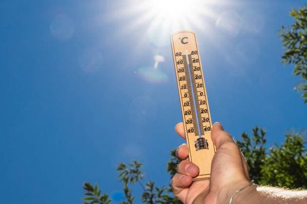Bavaria, Germany - 30 June 2025: A thermometer in front of bright sunlight shows temperatures close to 40 degrees - this motif symbolizes oppressive heat and the intensity of extreme summer days.