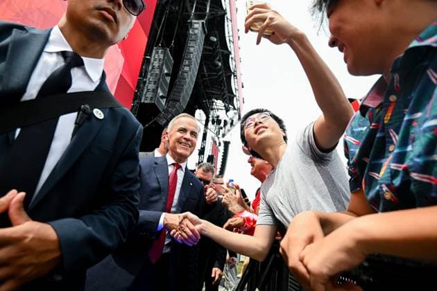July 1, 2025, Ottawa, On, Canada: Prime Minister Mark Carney takes a selfie with a spectator following mid-day Canada Day celebrations at LeBreton Flats in Ottawa, on Tuesday, July 1, 2025. Ottawa Canada  - ZUMAc35_ 20250701_zaf_c35_058 Copyright: xSpencerxColbyx