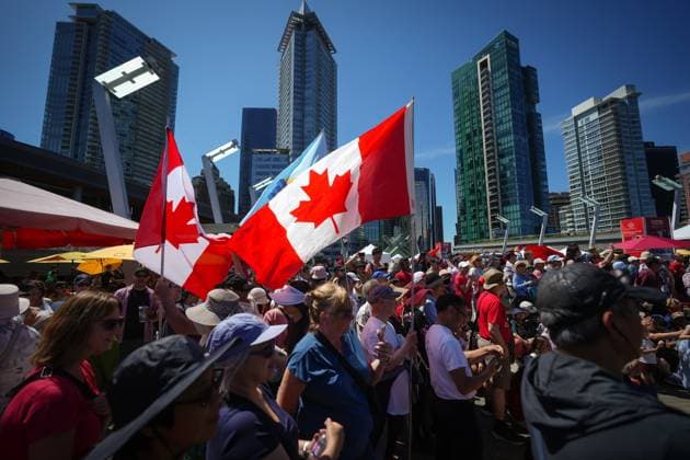 July 1, 2025, Vancouver, Bc, CANADA: Canadian flags being held by people flap in the wind during Canada Day festivities in Vancouver, on Tuesday, July 1, 2025. Vancouver CANADA  - ZUMAc35_ 20250701_zaf_c35_100 Copyright: xDarrylxDyckx