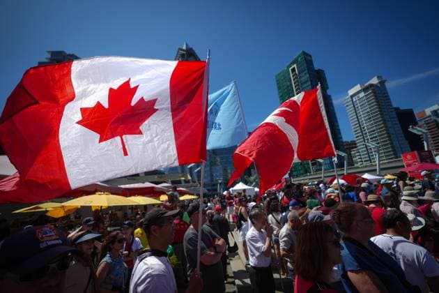 July 1, 2025, Vancouver, Bc, CANADA: Canadian flags being held by people flap in the wind during Canada Day festivities in Vancouver, on Tuesday, July 1, 2025. Vancouver CANADA  - ZUMAc35_ 20250701_zaf_c35_101 Copyright: xDarrylxDyckx