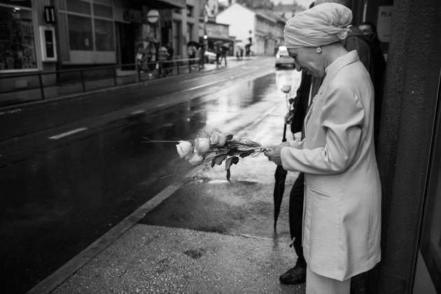 July 9, 2025, Potocari, Bosnia and Herzegovina: a woman is crying and holding flowers while waiting for the truck with the coffins of the seven people found this year, passing by in Sarajevo. a woman is placing flowers on the truck with the coffins of the seven people found this year. People in the background are praying. In 1995, during the Bosnian War, the city was the site of the killing of more than 8.000 Bosniak men and boys, perpetrated by the units of the Bosnian serb army of Republika Srpska, because they were muslim. This happened in a zone defined safe by United Nation (UN). On July 11, 2025, the International Day of Reflection and Commemoration of the 1995 Genocide in Srebrenica takes place. Potocari Bosnia and Herzegovina  - ZUMA 20250709_mda_b283_201 Copyright: xSebastianoxBaccix