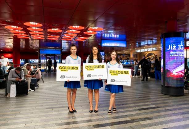 Hostesses with signs in the hall of the Main Railway Station, from where a special CD Colours express train take visitors to the Colours of Ostrava music festival from Prague to Ostrava, Prague Main Station, July 16, 2025. (CTKxPhoto HulinskaxAneta) CTKPhotoP2025071603922  CTKPhotoP2025071603922