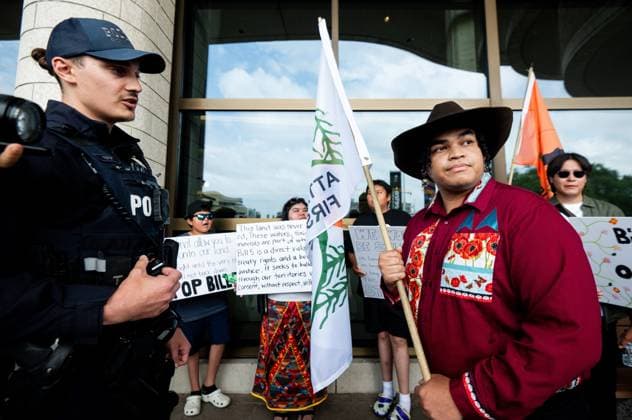 July 17, 2025, Gatineau, Qc, Canada: Protest organizer Ramon Kataquapit from the Okiniwak Youth Led Movement, right, reacts after being told to move off of the property of the Canadian Museum of History by a Royal Canadian Mounted Police officer during the First Nations Summit in Gatineau, Que., on Thursday, July 17, 2025. Gatineau Canada - ZUMAc35_ 20250717_zaf_c35_025 Copyright: xSpencerxColbyx