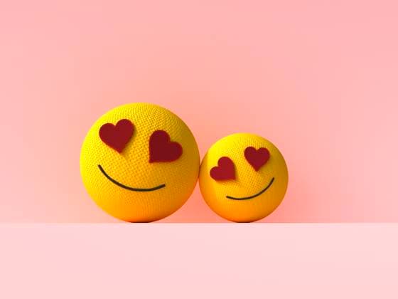 Two heart eyes emoji balls showing love and care on pink background, UWF01921