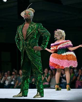 Broadway actor and singer Michael James Scott (L) and Ashley Eckstein introduce aspiring designers as they show off their geek couture outfits on the runway at the 11th Annual Her Universe Fashion Show during Comic-Con at the Seaport Ballroom of the Manchester Grand Hyatt in San Diego, California on Thursday, July 24, 2025. The fan-favorite event showcases work from designers across the country competing for the opportunity to design an exclusive apparel collection with Her Universe.  SDI20250724144 CHRISxCHEW