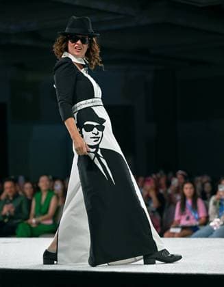 Designer Megg Waddington wears her Blues Brothers design as she walks down the runway at the 11th Annual Her Universe Fashion Show during Comic-Con at the Seaport Ballroom of the Manchester Grand Hyatt in San Diego, California on Thursday, July 24, 2025. The fan-favorite event showcases work from designers across the country competing for the opportunity to design an exclusive apparel collection with Her Universe.  SDI20250724145 CHRISxCHEW