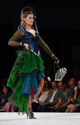 Designer Catherine Hart shows off her outfit as she walks down the runway at the 11th Annual Her Universe Fashion Show during Comic-Con at the Seaport Ballroom of the Manchester Grand Hyatt in San Diego, California on Thursday, July 24, 2025. The fan-favorite event showcases work from designers across the country competing for the opportunity to design an exclusive apparel collection with Her Universe.  SDI20250724137 CHRISxCHEW