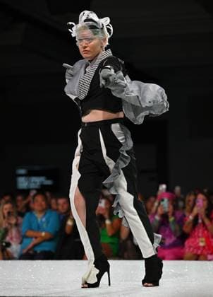 Designer Kiki shows off her outfit on the runway at the 11th Annual Her Universe Fashion Show during Comic-Con at the Seaport Ballroom of the Manchester Grand Hyatt in San Diego, California on Thursday, July 24, 2025. The fan-favorite event showcases work from designers across the country competing for the opportunity to design an exclusive apparel collection with Her Universe.  SDI20250724139 CHRISxCHEW