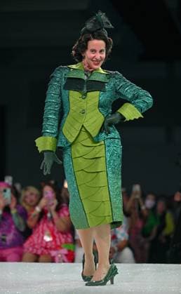 Designer Jen Wolff poses in her design entry on the runway at the 11th Annual Her Universe Fashion Show during Comic-Con at the Seaport Ballroom of the Manchester Grand Hyatt in San Diego, California on Thursday, July 24, 2025. The fan-favorite event showcases work from designers across the country competing for the opportunity to design an exclusive apparel collection with Her Universe.  SDI20250724147 CHRISxCHEW