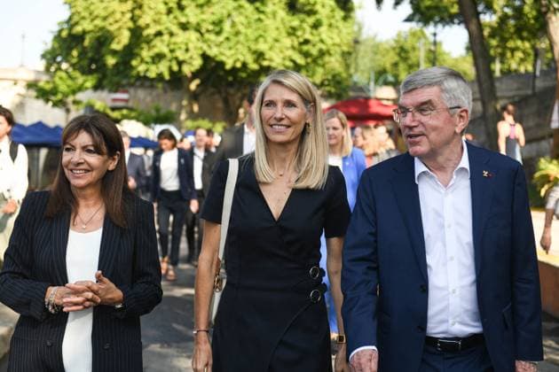 Celebrations marking the first anniversary of the Paris 2024 Olympic Games Paris Mayor Anne Hidalgo, Minister for Sports, Youth, and Community Life Marie Barsacq, Outgoing International Olympic Committee (IOC) president Thomas Bach walking towards the bras Marie area along the Seine river in Paris, France on July 26 2025 as part of the celebrations marking the first anniversary of the Paris 2024 Olympic Games. Photo by Florian Poitout ABACAPRESS.COM Paris France  Copyright: xPoitoutxFlorian ABACAx