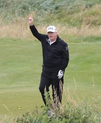 American President Donald Trump waves to the media whilst playing golf at Turnberry Golf Club, Ayrshire in Scotland on Sunday, July 27, 2025. Trump is on a four day visit to Scotland where he will be playing golf and meeting International leaders for trade discussions.  LON2025072701 HUGOxPHILPOTT