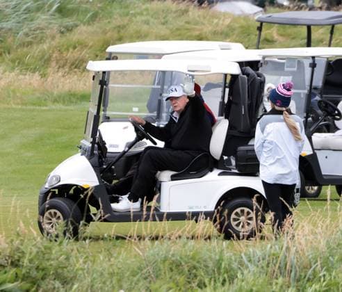 American President Donald Trump waves to the media whilst playing golf at Turnberry Golf Club, Ayrshire in Scotland on Sunday, July 27, 2025. Trump is on a four day visit to Scotland where he will be playing golf and meeting International leaders for trade discussions.  LON2025072710 HUGOxPHILPOTT