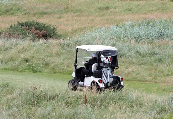 American President Donald Trump drives his golf buggy at Turnberry Golf Club, Ayrshire in Scotland on Sunday, July 27, 2025. Trump is on a four day visit to Scotland where he will be playing golf and meeting International leaders for trade discussions.  LON2025072713 HUGOxPHILPOTT