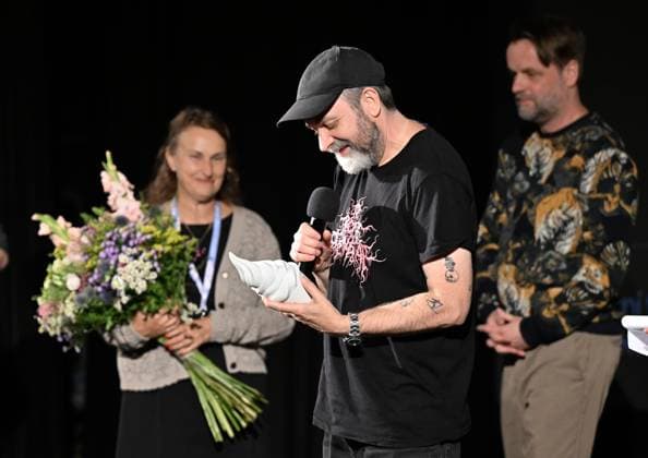 Lukas Moodysson, Swedish poet, novelist, film director and non-conformist, one of the most prominent personalities of the local culture in general, receives the ACFK Annual Award within the 51st Summer Film School in Uherske Hradiste, Czech Republic, July 27, 2025. From left: festival director Radana Korena, director Lukas Moodysson and programme director Jan Jilek. (CTKxPhoto DaliborxGluck) CTKPhotoP2025072705416  CTKPhotoP2025072705416