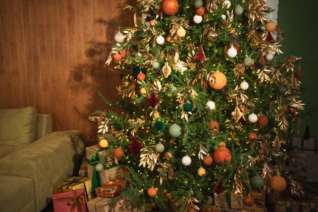 Frohe Weihnachten Xmas glückliche Feiertage. Goldenes Ornament Dekoration Ball und defokussiert Girlande Lichter auf klassische geschmückten Weihnachtsbaum. Weihnachtsbaum mit braunen Ornamenten. Heiligabend zu Hause. Merry Christmas Xmas happy holidays. Golden ornament decoration ball and defocused garland lights on classic decorated Christmas tree. Christmas tree with brown ornaments. Christmas eve at home (License=RF) ,model released, Symbolfoto Copyright: xZoonar.com IuliiaxZavalishinax 23778599 ,model released, Symbolfoto ,property released