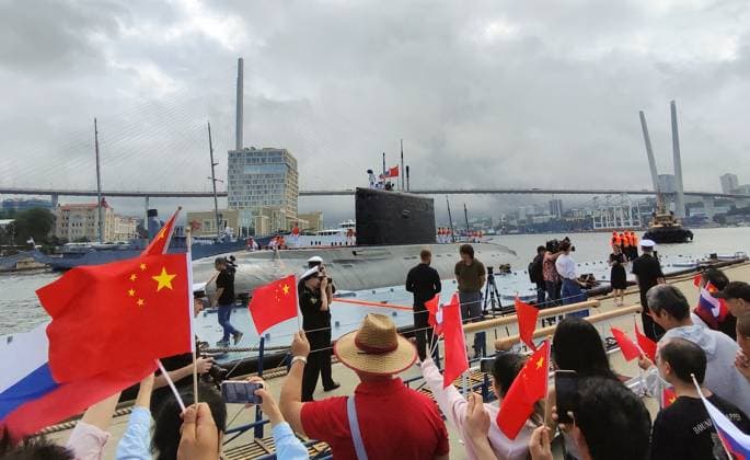 Russia China Naval Exercise 8975039 01.08.2025 In this handout photo released by the Russian Pacific Fleet, people attend the opening ceremony of the joint Russian-Chinese Maritime Interaction-2025 naval exercise, held from August 1-5 in the Sea of Japan, to facilitate the exchange of experience between Russian Navy and Chinese Peoples Liberation Army Navy sailors, in the far Eastern port of Vladivostok, Russia. The exercise is defensive in nature and not directed against other countries, the statement of Russian Pacific Fleet said, adding that the exercise will consist of shore-based and maritime phases. A command headquarters will be set up in the city of Vladivostok. Sputnik Image is a handout provided by a third party. Editorial use  Copyright: xx