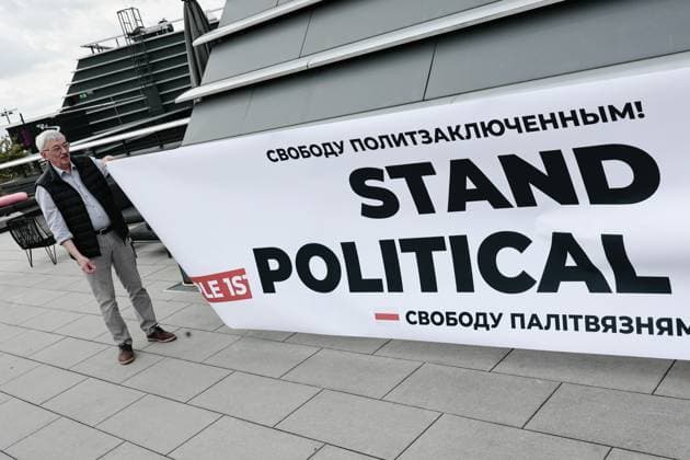 August 1, 2025, Cologne, Germany: Former Russian political prisoner Oleg Orlov holds a banner in solidarity with those who remain imprisoned in Russia, Belarus and Russian occupied parts of Ukraine. The act was part of a commemorative event marking the one-year anniversary of the largest political prisoner exchange since Soviet times. The event took place at the MOXY Cologne Bonn Airport hotel. It brought together several former detainees including human rights advocate Oleg Orlov, politician Andrei Pivovarov, activists Vadim Ostanin, Demuri Voronin, Herman Moises and Kevin Lick. Other speakers included Belarusian human rights defender Leanid Sudalenka, a former political prisoner and Liusiena Zinovkina whose husband is a Ukrainian civilian - ZUMAs197 20250801_aaa_s197_106 Copyright: xVasilyxKrestyaninovx