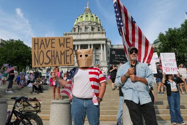 August 2, 2025, Harrisburg, Pennsylvania, United States: Demonstrators hold placards at the anti-Trump Rage Against the Regime protest at the Pennsylvania Capitol. The protest against the Donald Trump administration and its policies was part of the ninth National Day of Action organized by the 50501 Movement. Harrisburg United States - ZUMAs197 20250802_aaa_s197_390 Copyright: xPaulxWeaverx