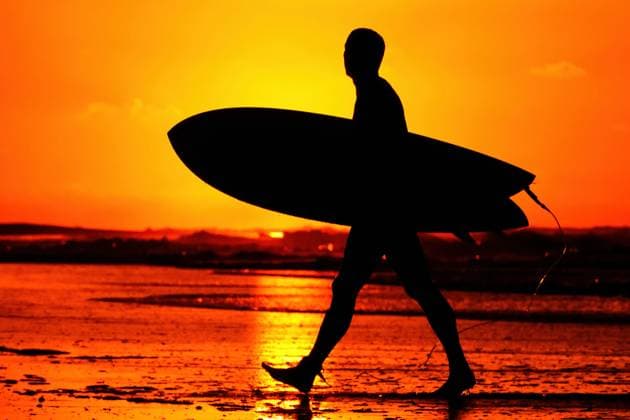 August 3, 2025, Isle Of Palms, Sc, United States: A surfer silhouetted by the sunrise, walks out of the water after an early morning surfing session at Wild Dune Beach, August 3, 2025 in Isle of Palms, South Carolina. Isle Of Palms United States - ZUMAe02_ 20250803_zaf_e02_002 Copyright: xRichardxEllisx