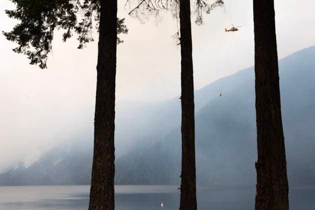 August 3, 2025, Coombs, Bc, CAN: A helicopter refills a bucket of water near Cameron Lake off Highway 4 where the Wesley Ridge wildfire continues to burn near Coombs, B.C., on Sunday, August 3, 2025. Coombs CAN  - ZUMAc35_ 20250803_zaf_c35_110 Copyright: xChadxHipolitox