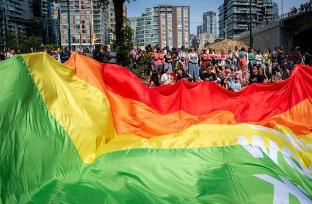 August 3, 2025, Vancouver, Bc, CANADA: People watch as a giant pride flag passes during the Vancouver Pride Parade in Vancouver, B.C., Sunday, Aug. 3, 2025. Vancouver CANADA  - ZUMAc35_ 20250803_zaf_c35_149 Copyright: xEthanxCairnsx