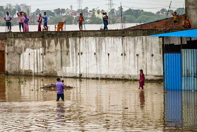 Residents Stranded as Yamuna River Floods Rise Flood-affected residents of a low-lying area stand on their rooftop on the banks of the Yamuna River in Prayagraj, India, on August 3, 2025, as water levels rise following continuous monsoon rains. The annual monsoon season brings critical rainfall to northern India, but also triggers frequent flooding, especially in vulnerable low-lying regions. Rising river levels force families to seek shelter on rooftops or evacuate their homes. The floods disrupt daily life, damage property, and pose health risks due to waterborne diseases and lack of clean water. Local authorities often struggle to provide timely relief and evacuation assistance. Scenes like this reflect the ongoing challenges of climate Copyright: xSANJAYxKANOJIAx