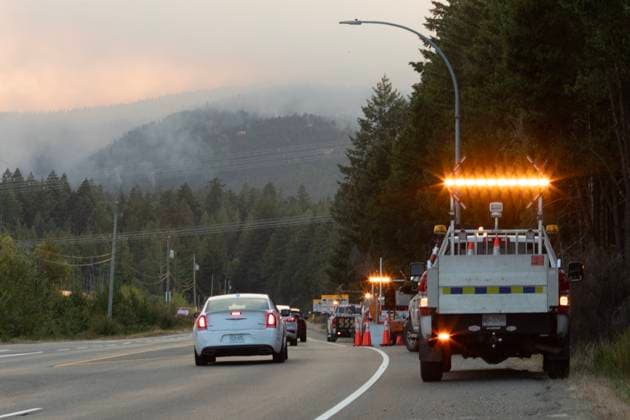 August 3, 2025, Coombs, Bc, CAN: A road crew awaits a potential closure along highway 4 as the Wesley Ridge wildfire burns out-of-control at Cameron Lake near Coombs, B.C., Sunday, Aug. 3, 2025. Coombs CAN  - ZUMAc35_ 20250803_zaf_c35_205 Copyright: xChadxHipolitox