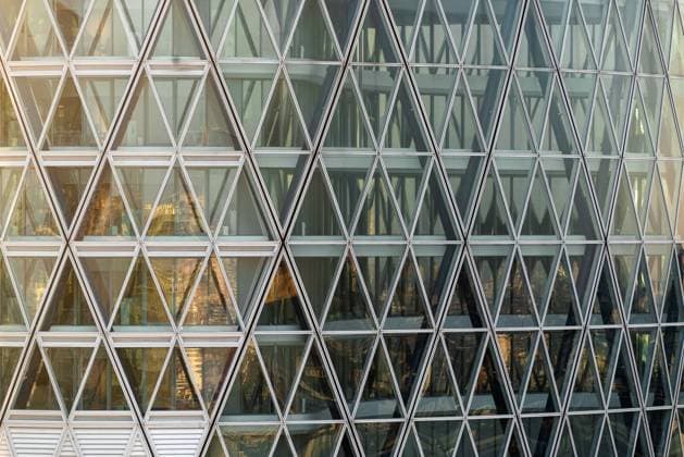 Close-up of the Unipol Tower facade with a triangular glass and steel structure, reflecting the surrounding urban environment at sunset. Milan (Italy), April 11th, 2025 Milan Italy - ZUMAesty 20250411_aac_m169_201 Copyright: xDimitarxHarizanovx