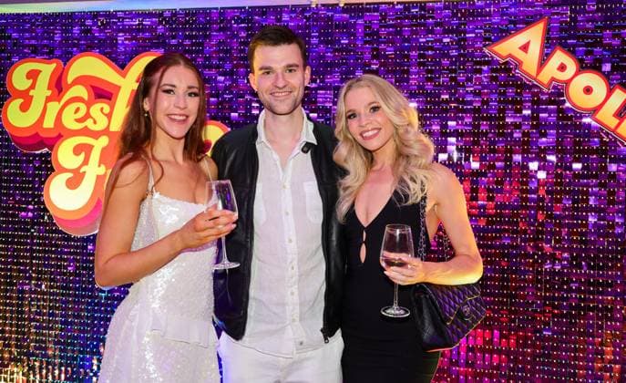 Roncalli s Apollo Variete Fresh n Funk premiere performance Actor Patrick Mölleken framed by two female artists at the After Show Party Düsseldorf Apollo NRW Germany