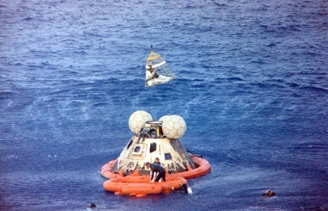 Astronaut John L. Swigert Jr., command module pilot, is lifted aboard a helicopter in a Billy Pugh helicopter rescue net while astronaut James A. Lovell Jr., commander, awaits his turn. Astronaut Fred W. Haise, Jr., lunar module pilot, is already aboard the helicopter. In the life raft with Lovell, and in the water are several U.S. Navy underwater demolition team swimmers, who assisted in the recovery operations. The crew was taken to the U.S.S. Iwo Jima, prime recovery ship, several minutes after the Apollo 13 spacecraft splashed down at 12:01:44 pm CST on April 17, 1970.. Copyright: xCNPx xMediaPunchx