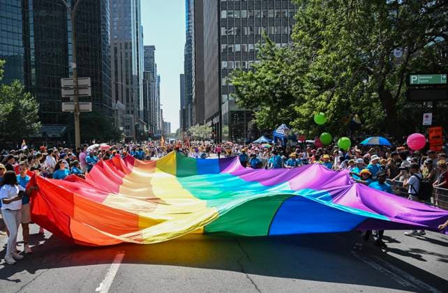 August 10, 2025, Montreal, Pq, Canada: Participants carry a rainbow flag along a street during the Pride parade in Montreal, Sunday, August 10, 2025. Montreal Canada  - ZUMAc35_ 20250810_zaf_c35_006 Copyright: xGrahamxHughesx