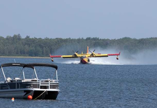 August 11, 2025, Shediac Bridge, Nb, Canada: A Quebec Water Bomber scoops water from Shediac Bay as the two Quebec based bombers help fight the forest fire in the Irishtown, N.B. area on Monday August 11, 2025. Shediac Bridge Canada  - ZUMAc35_ 20250811_zaf_c35_060 Copyright: xRonxWardx