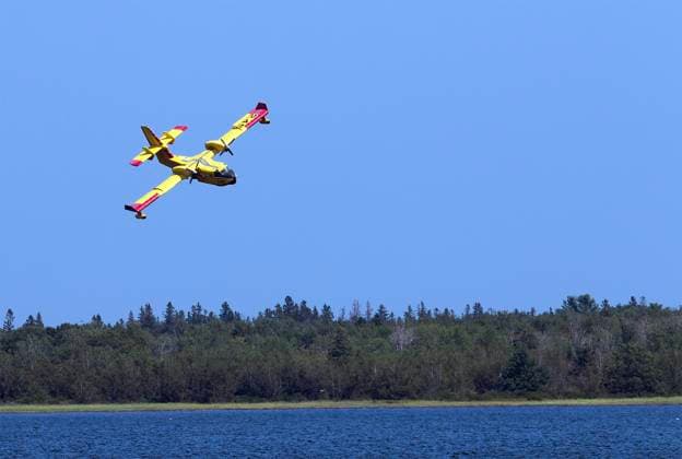 August 11, 2025, Shediac Bridge, Nb, Canada: A Quebec Water Bomber scoops water from Shediac Bay as the two Quebec based bombers help fight the forest fire in the Irishtown, N.B. area on Monday August 11, 2025. Shediac Bridge Canada  - ZUMAc35_ 20250811_zaf_c35_063 Copyright: xRonxWardx