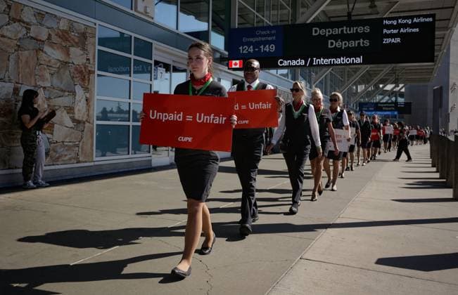 (250811) -- VANCOUVER, Aug. 11, 2025 -- Air Canada flight attendants arrive for a silent protest at Vancouver International Airport during a national day of action in Richmond, British Columbia, Canada, on Aug. 11, 2025. (Photo by Xinhua) CANADA-VANCOUVER-FLIGHT ATTENDANTS-PROTEST LiangxSen 