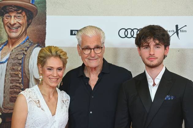 Sky DU MONT actor with companion Julia SCHUETZE and son Fayn movie premiere DAS KANU DES MANITU on 12 08 2025 at the Mathaeser Kino in Munich