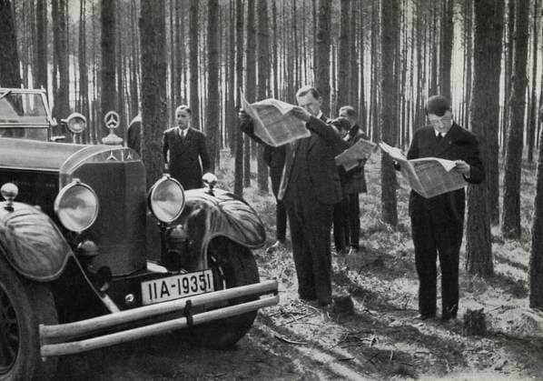 Adolf Hitler and Entourage Standing Alongside his Mercedes while Reading Newspapers in the Woods, Germany, early 1930 s  Copyright: xABxArchivex jtv010423