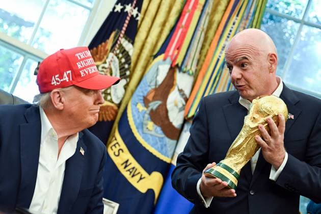 FIFA President Gianni Infantino hands President Donald Trump the FIFA World Cup trophy after announcing the 2026 World Cup draw will be held at the Kennedy Center in December in the Oval Office of the White House in Washington, DC on Friday, August 22, 2025. The FIFA World Cup, coming to North America next summer will be the first World Cup with three host countries in the U.S., Canada and Mexico, and it will be the first to feature a 48-team field.  WAP20250822345 BONNIExCASH