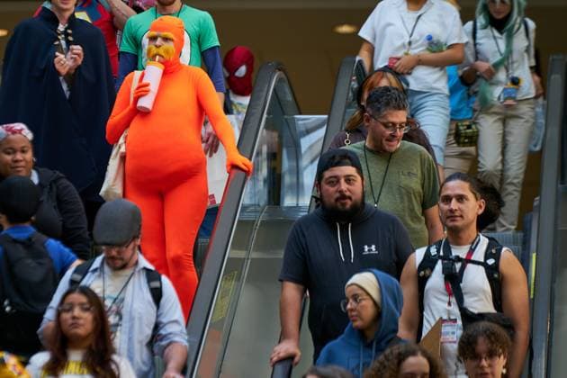 August 22, 2025, Toronto, On, Canada: Dressed as the Lorax, Hannah Henley (top left) makes her way down the escalators on the second day of the annual Fan Expo convention in Toronto, on Friday, Aug. 22, 2025. Toronto Canada  - ZUMAc35_ 20250822_zaf_c35_154 Copyright: xSammyxKoganx