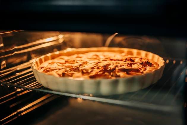 Charlotte pie baking in oven in cozy country kitchen in autumn property released, VSNF03888