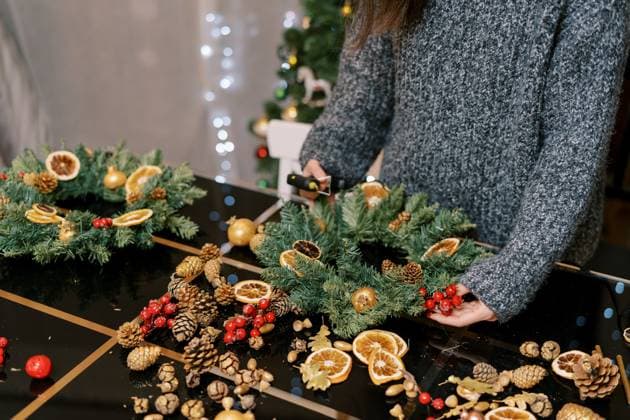 Artist applies glue to a branch of red berries for a New Year wreath on the table. Cropped. Faceless Artist applies glue to a branch of red berries for a New Year wreath on the table. Cropped. Faceless. High quality photo, model released, , 63154022.jpg RECORD DATE NOT STATED