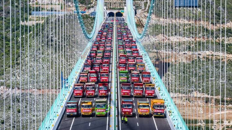 (250826) -- BEIJING, Aug. 26, 2025 -- This aerial drone photo taken on Aug. 25, 2025 shows a load test on the Huajiang Grand Canyon Bridge in southwest China s Guizhou Province. The Huajiang Grand Canyon Bridge, set to become the world s tallest bridge, had completed a key load test as of Monday, ahead of its scheduled opening in late September. The bridge is 2,890 meters long with a main span of 1,420 meters. Rising 625 meters above the river, it will set the record for both the tallest bridge in the world and the world s largest span bridge built in a mountainous area, upon completion. ) XINHUA PHOTOS OF THE DAY TaoxLiang 