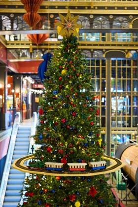 A festive Christmas Tree adorned with delightful ornaments and a wonderful train display A beautifully decorated Christmas tree featuring colorful ornaments and a train display in a festive setting., 63706860.jpg RECORD DATE NOT STATED
