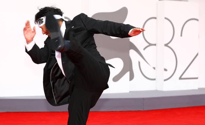 August 29, 2025, Venice, Veneto, Italy: A guest practices Karate kicks on the red carpet for the At Work (A Pied d Oeuvre) premiere screening at the 82nd Venice Film Festival at the Venice Lido, Italy. Venice Italy - ZUMAc179 20250829_zep_c179_097 Copyright: xMickaelxChavetx