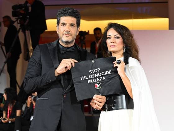Venice, 82nd Venice International Film Festival 2025 - Evening 3 - The Red Carpet for the film Calle Malaga. Pictured: Stop the Genocide in Gaza: Nabil Ayouch, Maryam Touzani  Copyright: xManuelexMangiarottix xipa-agency.netx xPoolxPhotoxEventsx06x IPA_Agency_IPA63587614